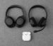Over-ear headphones, a boom-microphone headset, and wireless earbuds arranged on a desk.