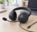 Black wired headset with boom microphone and USB-C cable on an office desk